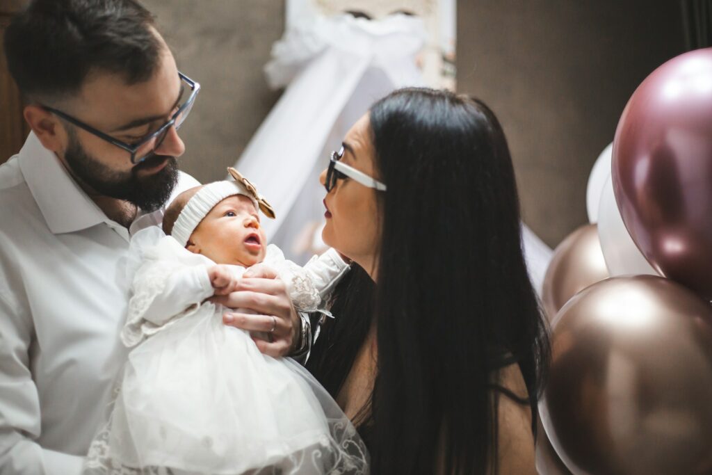 Parents holding their newborn baby girl